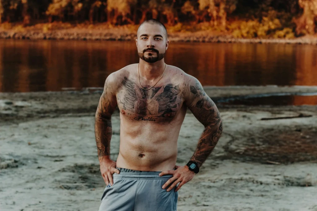 photo - a man standing in a river representing some of the best chest tattoos for men