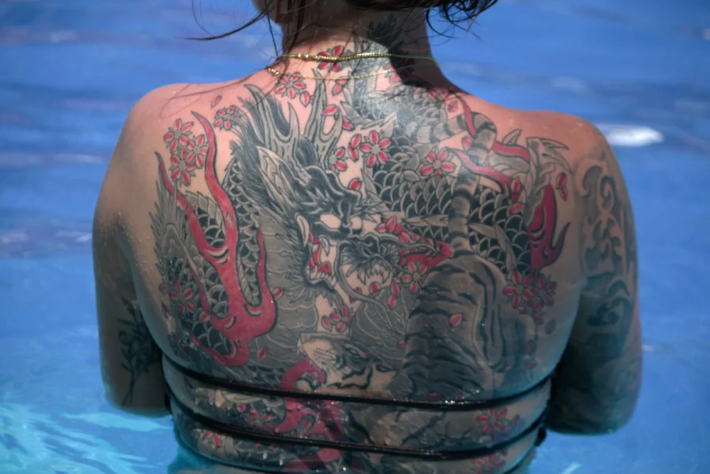 photo - a woman with a traditional japanese back tattoo
