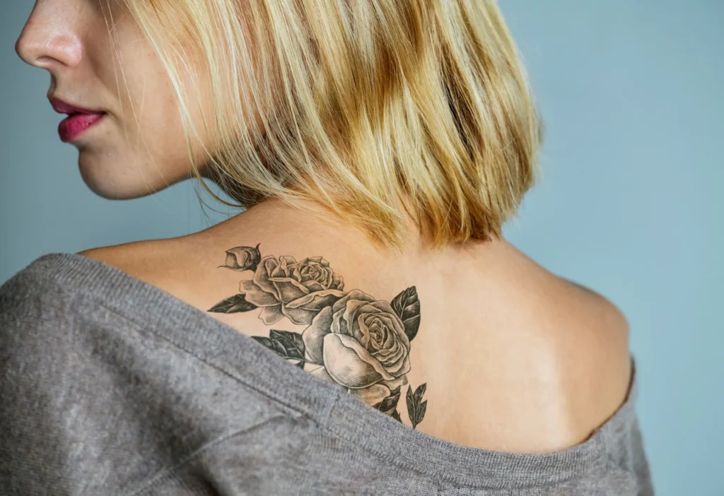 photo - a woman with good tattoo placement looking to the side with an exposed shoulder tattoo