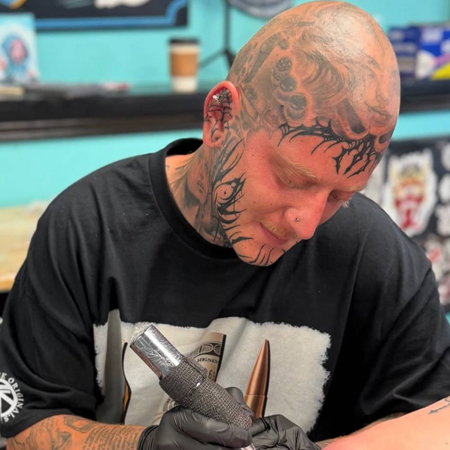 Tattoo and piercing shop in Denver County CO artist creating design