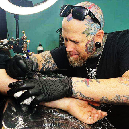 Flash tattoo artist working on client in Denver, CO