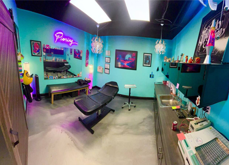Tattoo and piercing shop Aurora CO artist creating detailed tattoo design