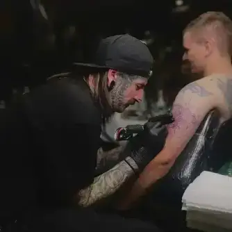 Artist consulting with a client on a design idea