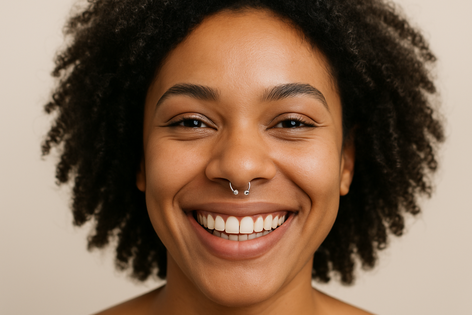 photo - a woman with a septum piercing smiling at the camera